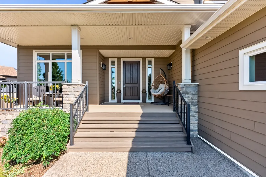 Covered front porch with hanging chair