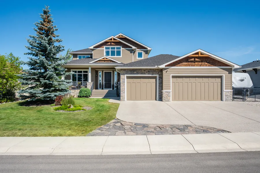 Front elevation, triple garage and driveway